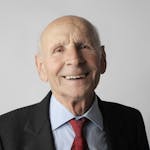 Portrait of a happy senior man in a suit. Ideal for lifestyle and senior care imagery.