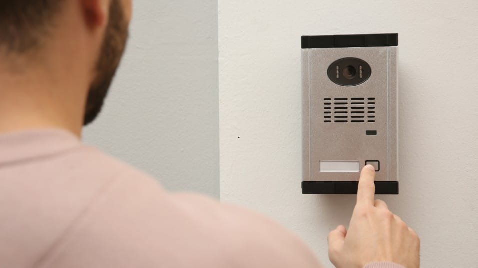 Locksmith installing a smart lock on a front door as part of a Denver home security upgrade